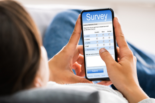 Woman filling in survey on mobile phone